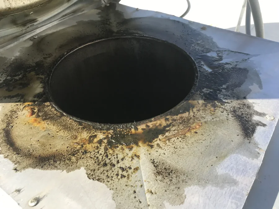 Grease buildup surrounding a rooftop exhaust opening